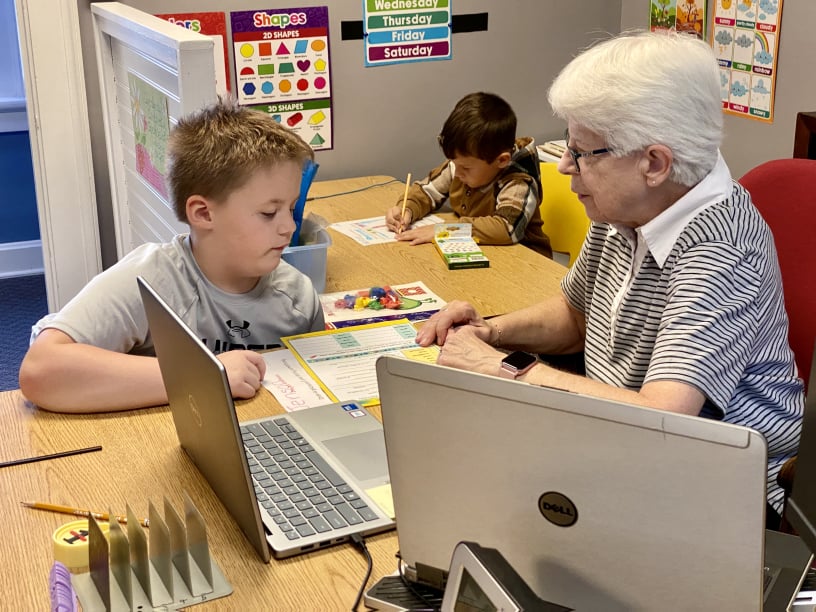 student working with teacher